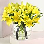 Cheerful Yellow Lilies In Fishbowl Vase