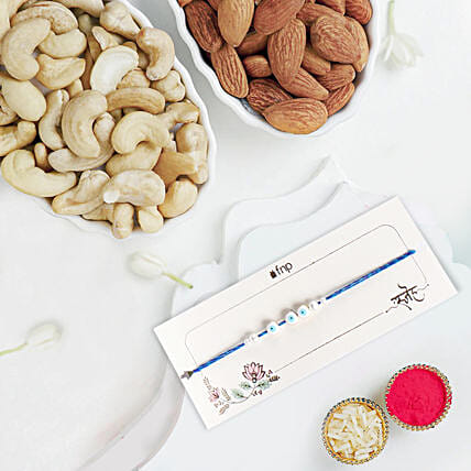 Simplistic Blue Evil Eye Rakhi With Almonds and Cashew: Rakhi With Dryfruits 