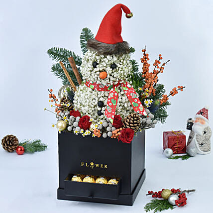 ورد على شكل رجل ثلج في صندوق أسود وشوكولاتة فيريرو روشيه: 