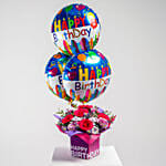 زهور وردية وبنفسجية في مزهرية لعيد الميلاد مع بالونات