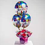 زهور وردية وبنفسجية في مزهرية لعيد الميلاد مع بالونات