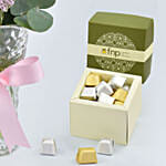 Three Tulips in a Vase With Chocolates