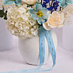 Elegant Blue and White Flower Arrangement in Ceramic Vase