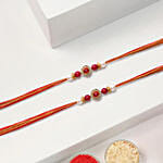 Red Pearl Rakhi Set Of 2 With 6 Raksha Bandhan Cupcakes